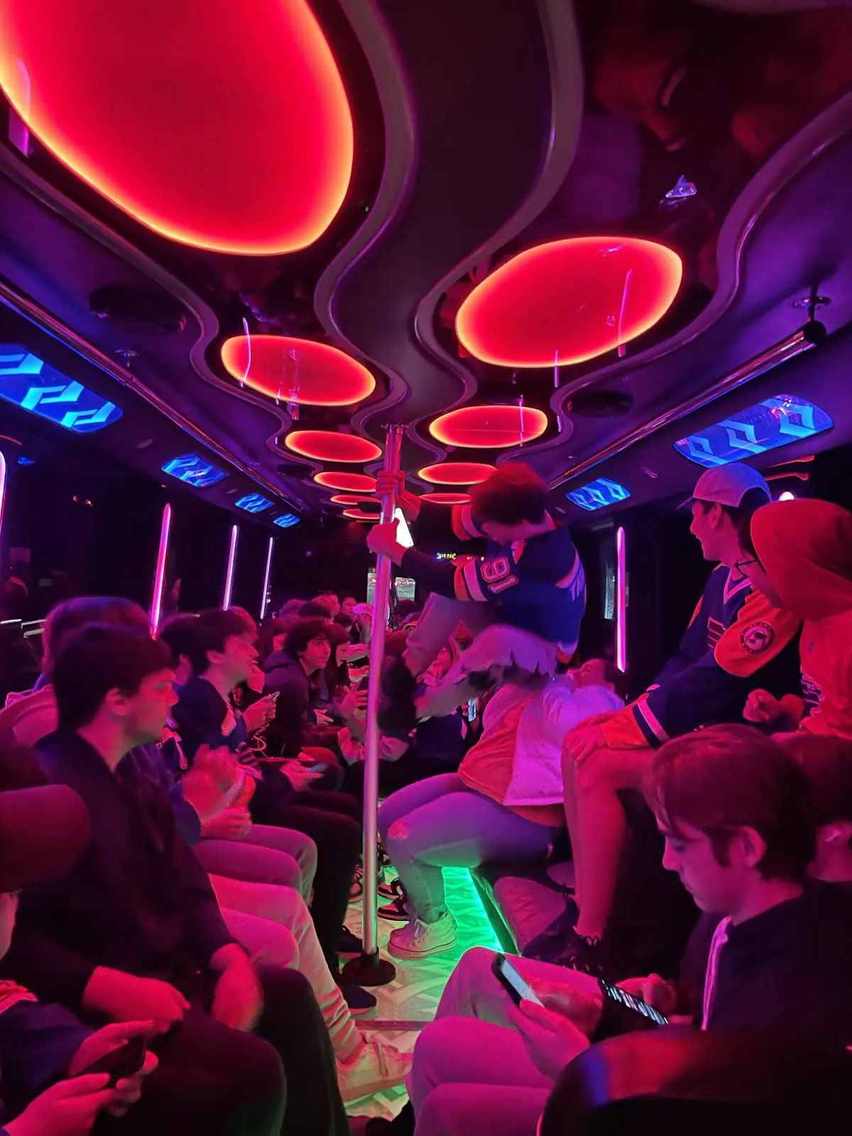 Group of guests inside a red-lit circular-ceiling cabin