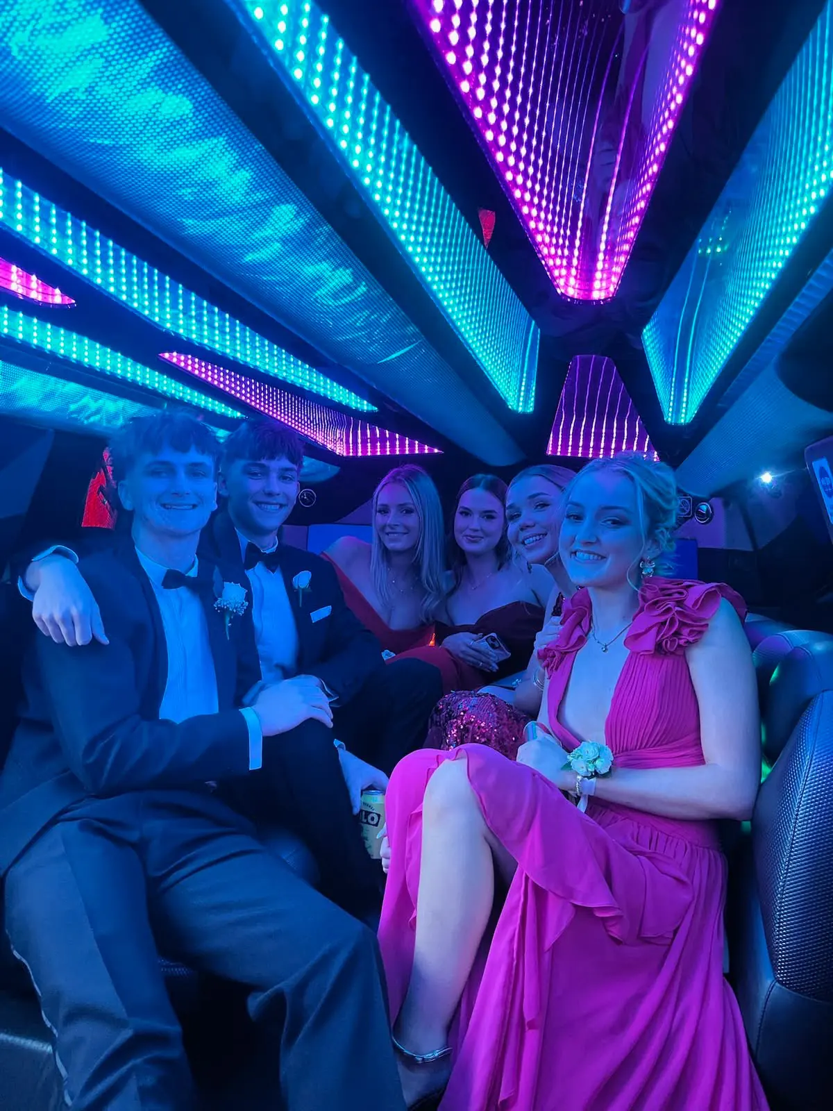 Guests seated in a blue-lit party cabin