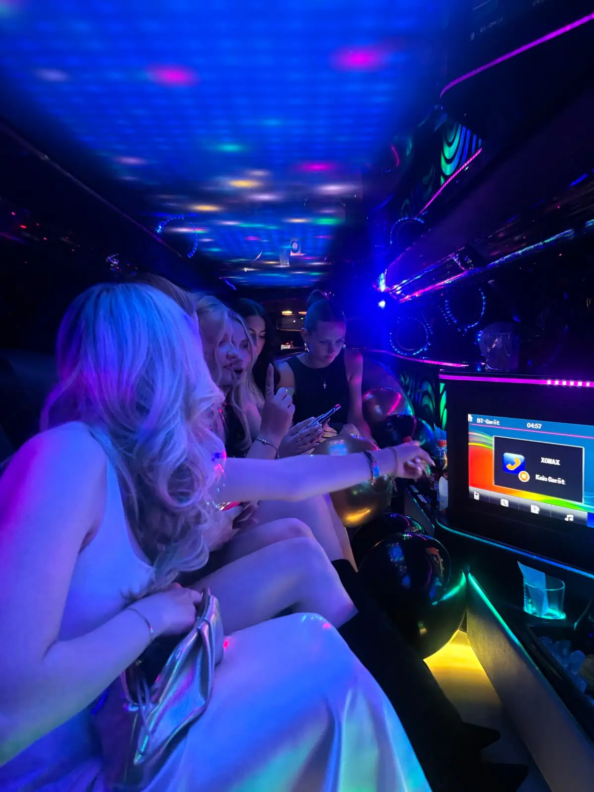 Guests seated together in a blue-lit cabin