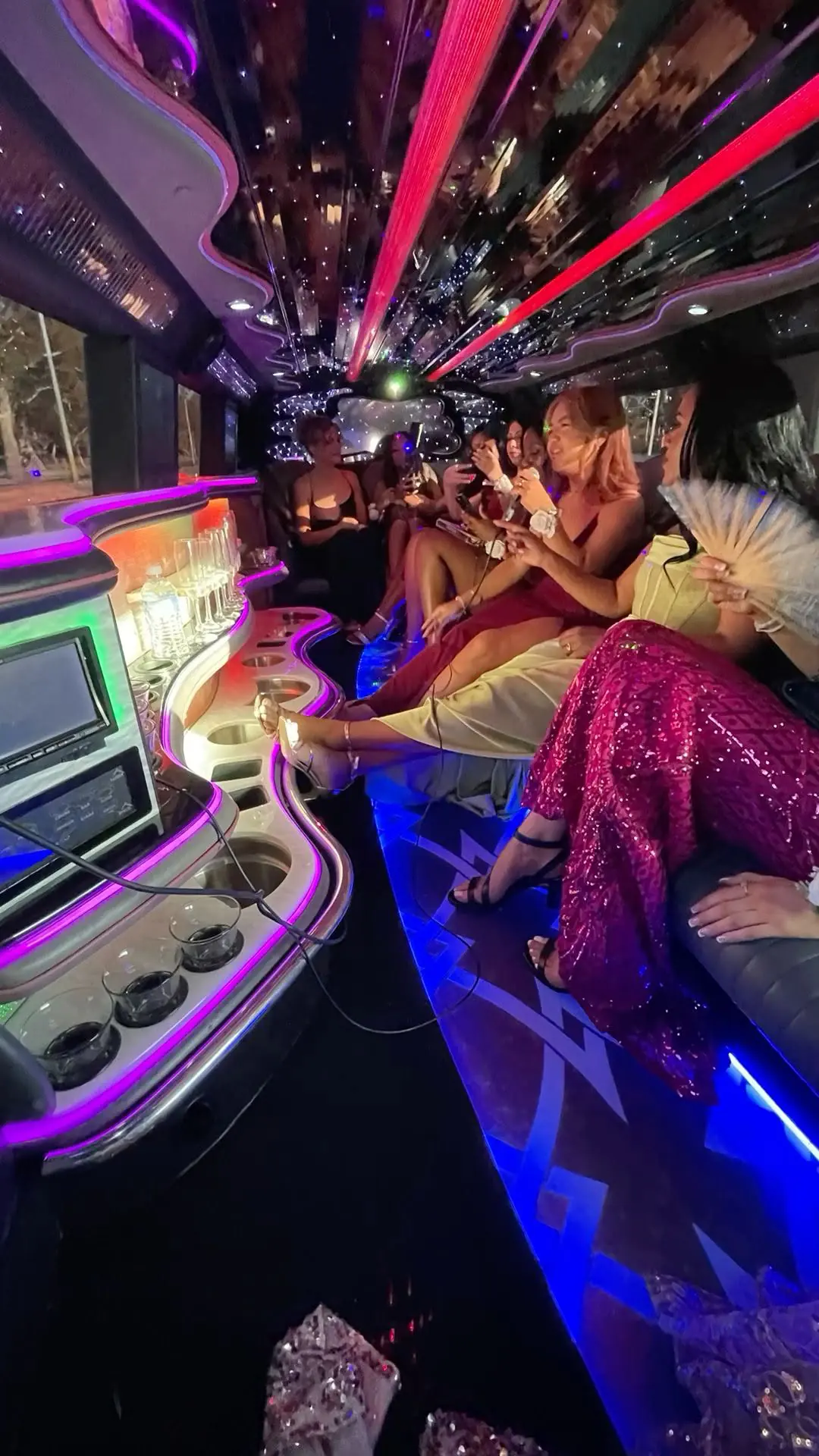 Guests inside an illuminated limousine cabin