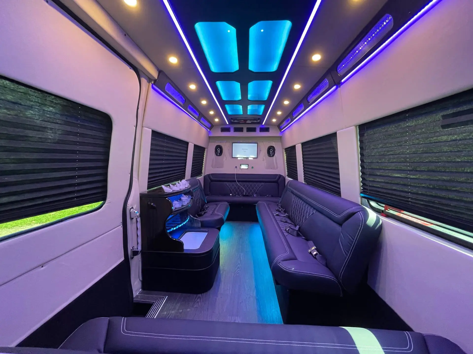 Wide purple and cyan lit lounge cabin interior