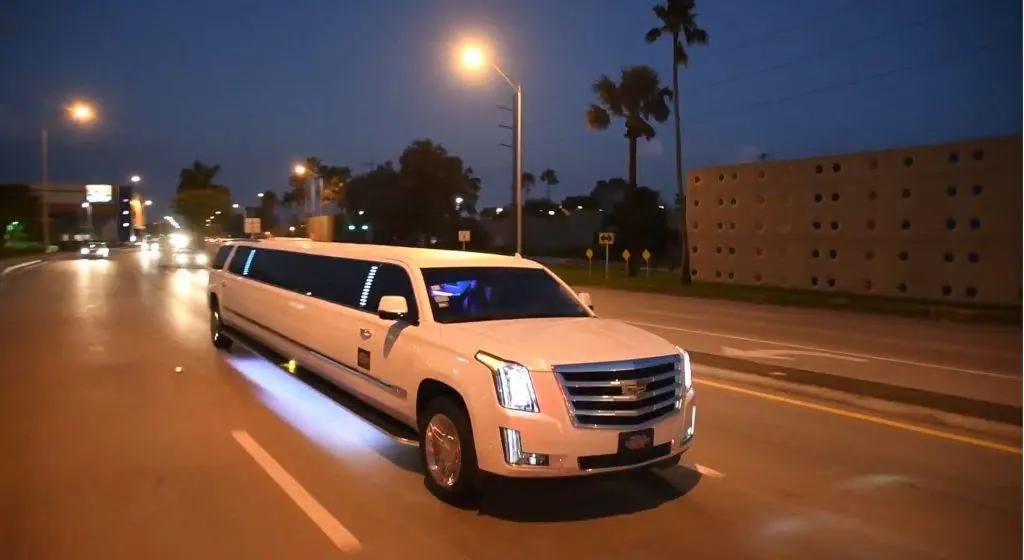 White stretch limousine photographed at dusk