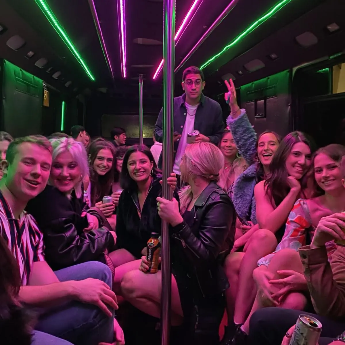 Group celebrating inside an illuminated bus