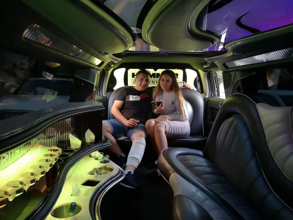 Two guests seated in a limousine cabin